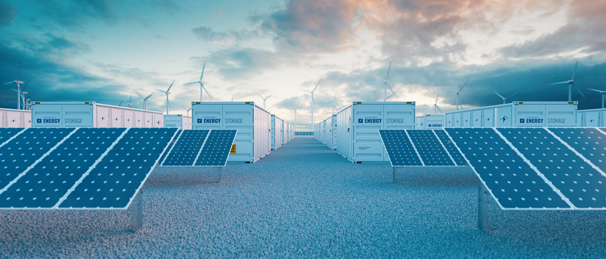 large-scale batteries in cargo containers amid solar panels and wind turbines