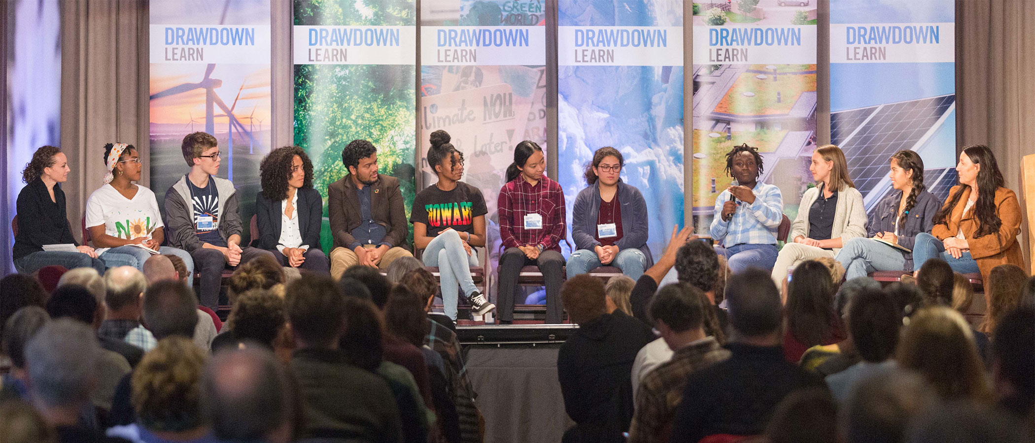 A panel of students on stage discussing climate solutions at the Drawdown Learn conference