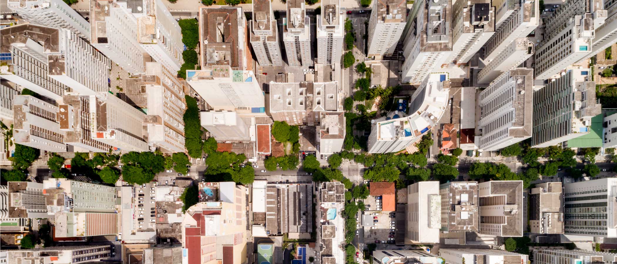 Aerial view of an urban residential neighborhood with apartment towers, courtyards, and open space.