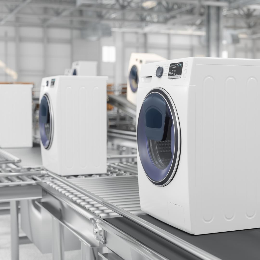 Washing machines on conveyer belts in a factory
