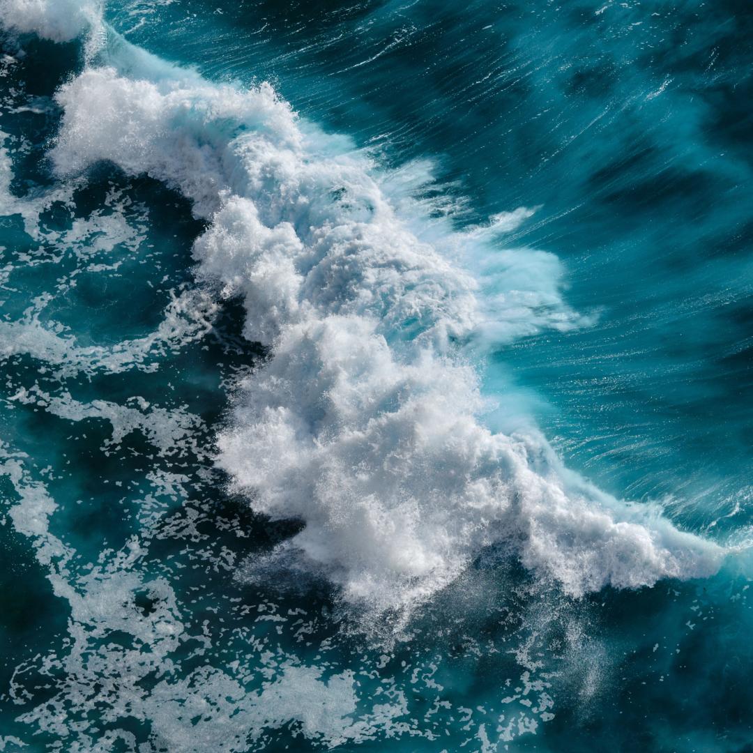 An image of the frothy crest of a wave