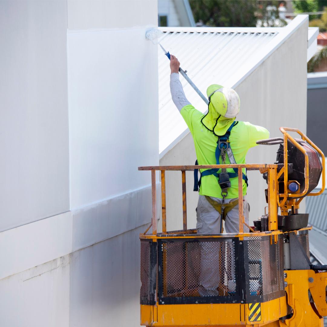 Worker spraying a coating on a surface