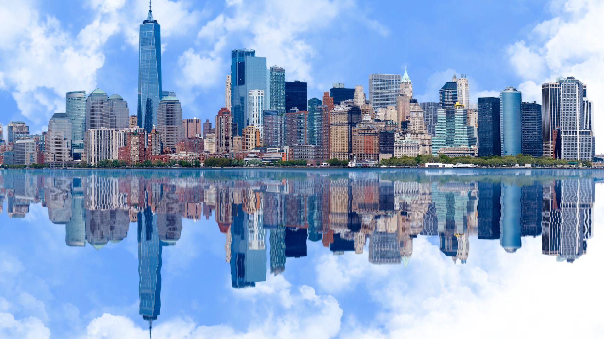 An image of the New York City skyline reflected in water with a cloud overlay