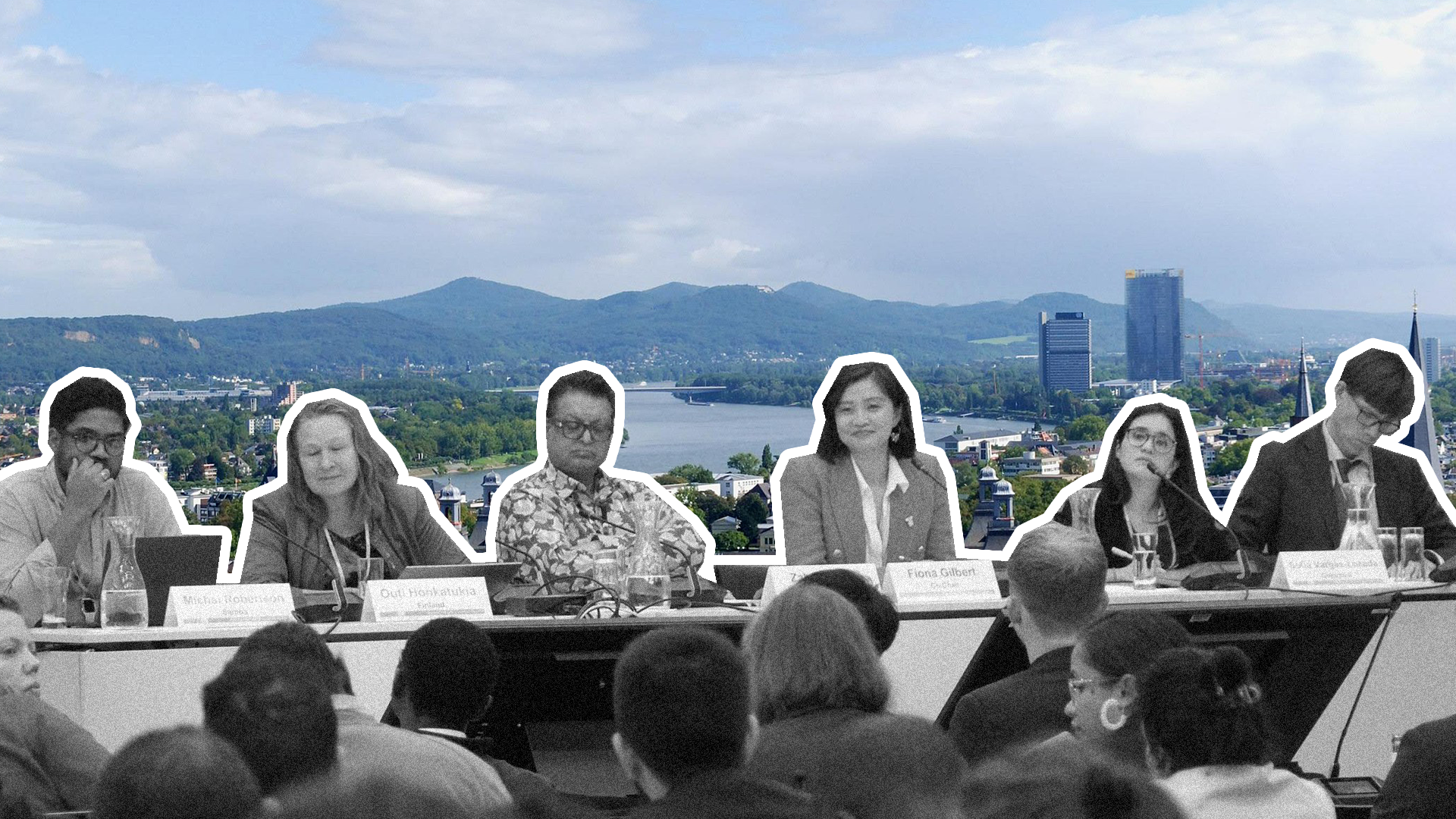 A group of climate negotiators with Bonn, Germany in the background
