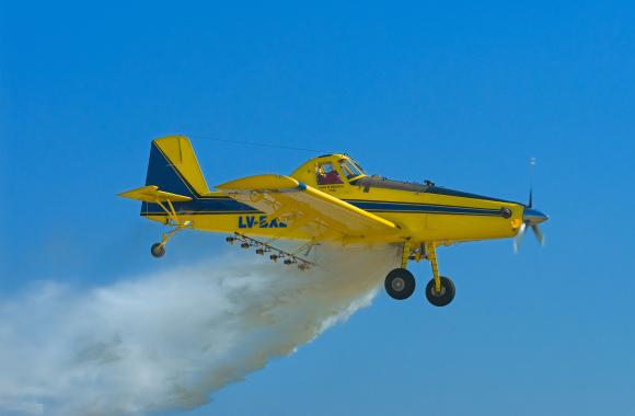 Airplane releasing material into the air